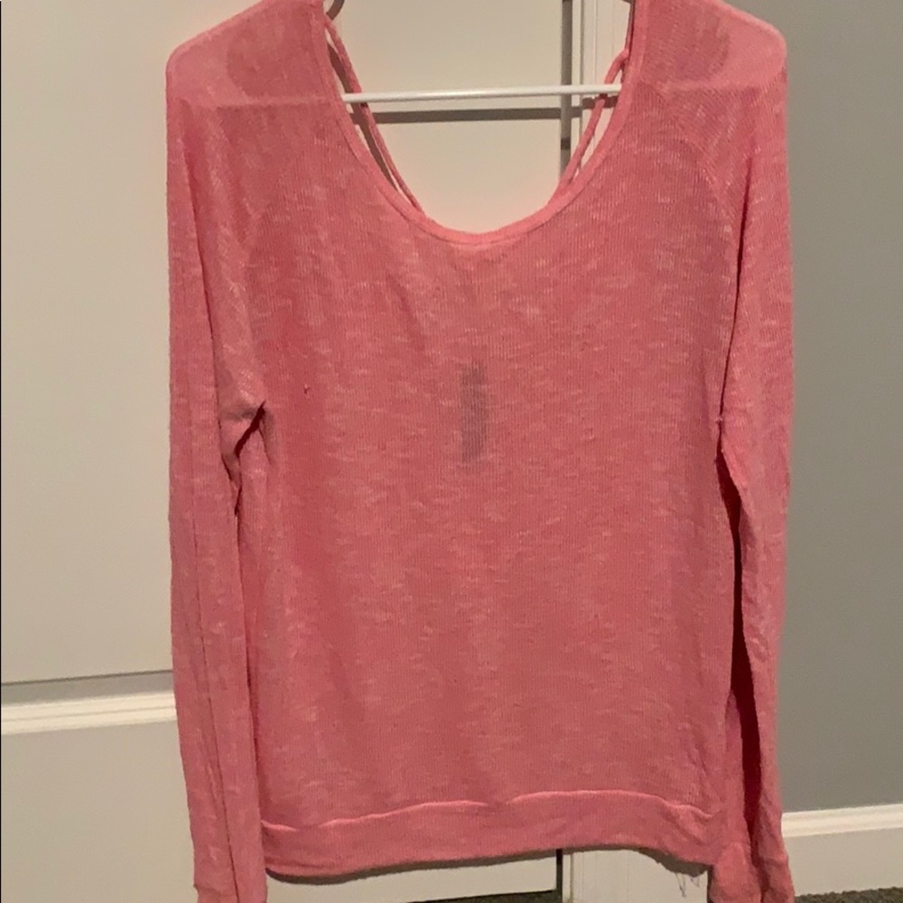 Aero pink sweater with open back.